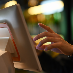 Close up of saleswoman hands accounting, billing some goods for sale in retail.