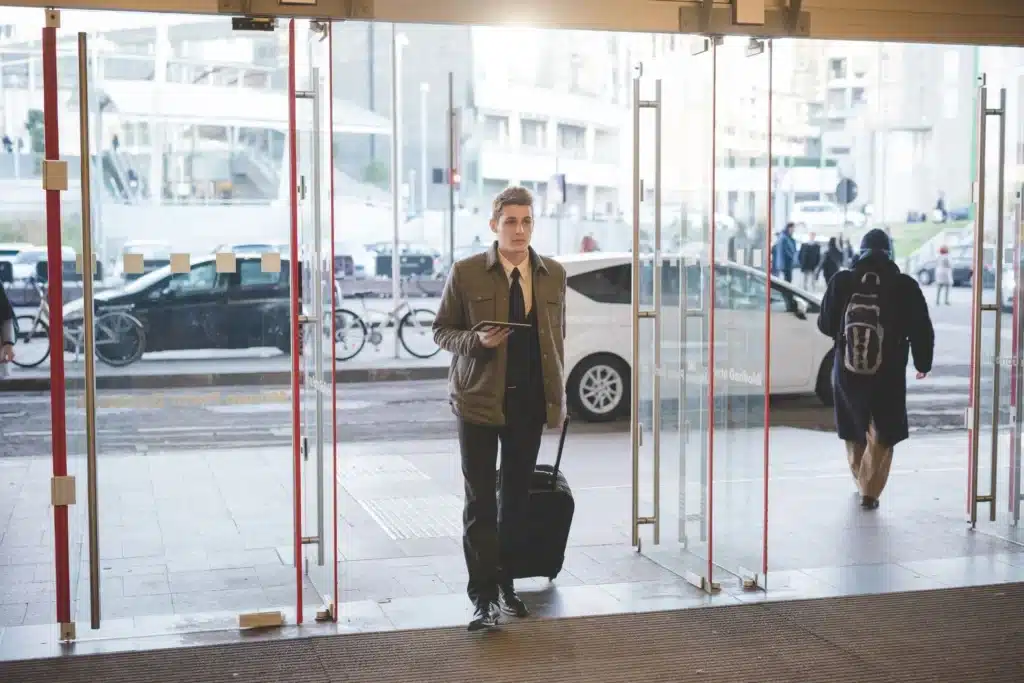 man walking through glass doors